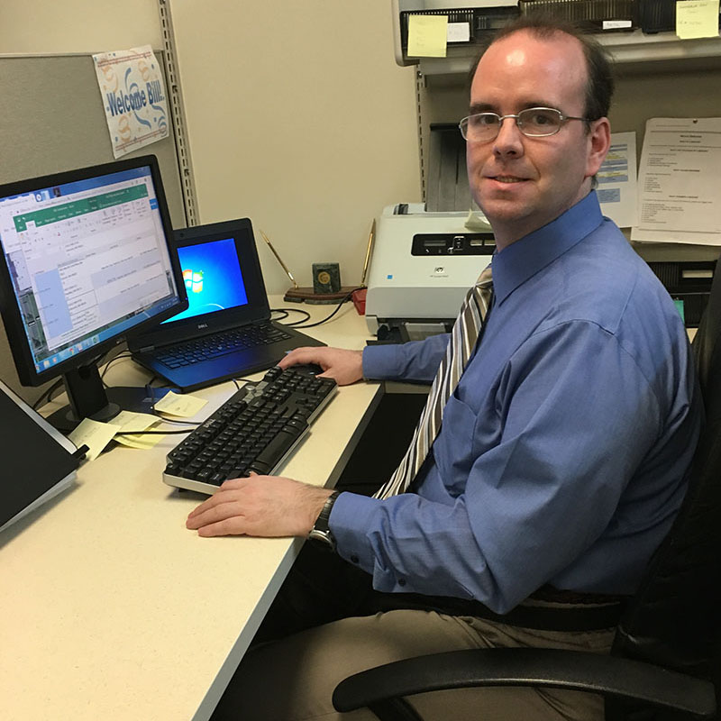Man sitting at a desk working on a computer